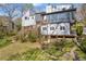View of the backyard with a deck and stairs leading to the lush greenery at 10845 Shallowford Rd, Roswell, GA 30075