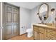 The bathroom boasts a rustic vanity, toilet, and decorative lighting fixture at 10845 Shallowford Rd, Roswell, GA 30075