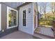 Exterior view of home entrance with deck and orange door at 10845 Shallowford Rd, Roswell, GA 30075