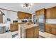 Traditional kitchen featuring wood cabinetry, granite countertops, and stainless steel appliances at 10845 Shallowford Rd, Roswell, GA 30075