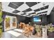 Living room showcasing a checkerboard ceiling, patio access, and a television at 10845 Shallowford Rd, Roswell, GA 30075