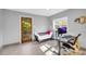 Bright office with a gray walls, a work desk and chair, and a door to the outside at 10845 Shallowford Rd, Roswell, GA 30075