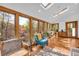 Bright sunroom with multiple windows offering a view of the surrounding trees and natural light at 10845 Shallowford Rd, Roswell, GA 30075