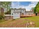 Two-story home featuring a deck, covered patio, and a partially fenced yard at 1647 Grandeus Sw Ln, Stone Mountain, GA 30087