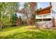 Large backyard with a deck, mature trees, and a well-maintained lawn at 1647 Grandeus Sw Ln, Stone Mountain, GA 30087