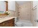 Charming bathroom featuring tiled walls, a vanity with countertop, and a bathtub with shower at 1647 Grandeus Sw Ln, Stone Mountain, GA 30087