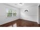 Cozy bedroom with hardwood floors, crown molding, a large window, and a unique architectural detail at 1647 Grandeus Sw Ln, Stone Mountain, GA 30087