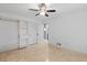 Bright bedroom featuring neutral walls, tile floor, a ceiling fan and a large built-in closet system at 1647 Grandeus Sw Ln, Stone Mountain, GA 30087