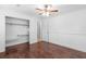 Bedroom with hardwood floors and a closet with organizers for convenient storage at 1647 Grandeus Sw Ln, Stone Mountain, GA 30087