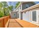Large wood deck with ample space for entertaining, featuring white railings, and house with double doors at 1647 Grandeus Sw Ln, Stone Mountain, GA 30087