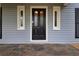 Elegant front door with decorative glass panels, sidelights, and slate tile porch at 1647 Grandeus Sw Ln, Stone Mountain, GA 30087