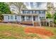 Charming two-story home with a blue siding, a porch, landscaped yard and lots of character at 1647 Grandeus Sw Ln, Stone Mountain, GA 30087