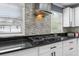 Close up of the kitchen backsplash with the stove in view, and countertops at 1647 Grandeus Sw Ln, Stone Mountain, GA 30087