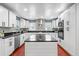 Bright, modern kitchen with white cabinets, black hardware and countertops, and a central island at 1647 Grandeus Sw Ln, Stone Mountain, GA 30087