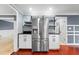 Kitchen features a stainless steel refrigerator, dark countertops, white cabinets, and view to a connected room at 1647 Grandeus Sw Ln, Stone Mountain, GA 30087