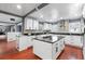 Bright kitchen featuring white cabinets, a gray backsplash, black countertops and stainless steel appliances at 1647 Grandeus Sw Ln, Stone Mountain, GA 30087