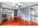 Living room featuring hardwood floors, neutral walls, and view to the kitchen at 1647 Grandeus Sw Ln, Stone Mountain, GA 30087