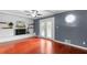Living room showing the fireplace with hardwood floors, neutral walls, and access to the back yard at 1647 Grandeus Sw Ln, Stone Mountain, GA 30087