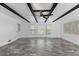 Spacious living room with beamed ceilings, a ceiling fan, large windows and modern floors at 1647 Grandeus Sw Ln, Stone Mountain, GA 30087