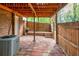 Enclosed patio with brick flooring and wood fence providing a private outdoor space, including AC unit at 1647 Grandeus Sw Ln, Stone Mountain, GA 30087
