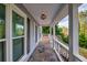Covered porch with tile flooring and white railings, providing a relaxing outdoor space at 1647 Grandeus Sw Ln, Stone Mountain, GA 30087
