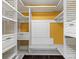Spacious walk-in closet with custom organizers for efficient storage and a pop of color at 1647 Grandeus Sw Ln, Stone Mountain, GA 30087