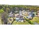 A neighborhood of homes with well manicured yards with mature trees on a sunny day from above at 2245 Friars Gate Dr, Lawrenceville, GA 30043