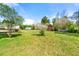 Expansive backyard featuring a lush lawn, mature trees, and a charming deck, perfect for outdoor entertaining at 2245 Friars Gate Dr, Lawrenceville, GA 30043
