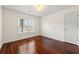 A bright bedroom with pristine walls, rich wood floors, and a charming chandelier at 2245 Friars Gate Dr, Lawrenceville, GA 30043