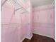 Walk-in closet with wire shelving and pink walls, ready for organization at 2245 Friars Gate Dr, Lawrenceville, GA 30043