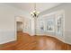 Elegant dining room featuring hardwood floors, wainscoting, and a charming bay window at 2245 Friars Gate Dr, Lawrenceville, GA 30043