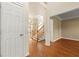 Inviting foyer with hardwood floors, a staircase and multiple doorways leading to other rooms at 2245 Friars Gate Dr, Lawrenceville, GA 30043