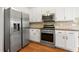 Modern kitchen featuring stainless steel appliances and white cabinetry at 2245 Friars Gate Dr, Lawrenceville, GA 30043