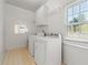 Functional laundry room with washer, dryer, and storage shelving at 2245 Friars Gate Dr, Lawrenceville, GA 30043
