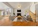 Cozy living room with a fireplace, hardwood floors, and plenty of natural light at 2245 Friars Gate Dr, Lawrenceville, GA 30043