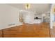 Open-concept living room featuring hardwood floors, staircase, and view of kitchen and bright, airy feel at 2245 Friars Gate Dr, Lawrenceville, GA 30043