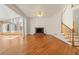 Spacious living room with brick fireplace, large windows, and staircase at 2245 Friars Gate Dr, Lawrenceville, GA 30043