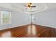 Spacious main bedroom with hardwood floors, tray ceiling, and ample natural light at 2245 Friars Gate Dr, Lawrenceville, GA 30043