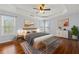 Serene main bedroom with hardwood floors, tray ceiling, ample natural light, and stylish décor at 2245 Friars Gate Dr, Lawrenceville, GA 30043