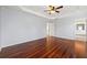 Spacious main bedroom with hardwood floors, tray ceiling, open concept view to bathroom at 2245 Friars Gate Dr, Lawrenceville, GA 30043