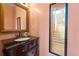 Charming powder room with dark wood vanity, decorative mirror, and stylish accents at 2245 Friars Gate Dr, Lawrenceville, GA 30043