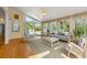 Bright sunroom with lots of windows, hardwood floors, and comfortable seating at 2245 Friars Gate Dr, Lawrenceville, GA 30043
