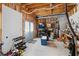 Unfinished basement with exposed beams, door to exterior, and workbench area at 4020 Balleycastle Ln, Duluth, GA 30097
