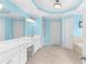 Bright bathroom featuring double sinks, white cabinetry, and a white stool at 4020 Balleycastle Ln, Duluth, GA 30097