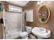 Cozy bathroom featuring a pedestal sink and a shower-tub combination at 4020 Balleycastle Ln, Duluth, GA 30097