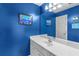 Modern blue bathroom featuring a single sink with bright and colorful walls at 4020 Balleycastle Ln, Duluth, GA 30097