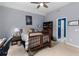 Spacious bedroom with a ceiling fan, carpet, and a window with views leading to bathroom at 4020 Balleycastle Ln, Duluth, GA 30097