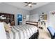 Spacious bedroom with a ceiling fan, carpet, and a window with views and white closet doors at 4020 Balleycastle Ln, Duluth, GA 30097