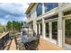 Spacious wooden deck with dining area, featuring large windows and doors for easy indoor-outdoor living at 4020 Balleycastle Ln, Duluth, GA 30097
