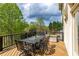 Outdoor deck featuring a metal table with seating for eight and a wooded view at 4020 Balleycastle Ln, Duluth, GA 30097
